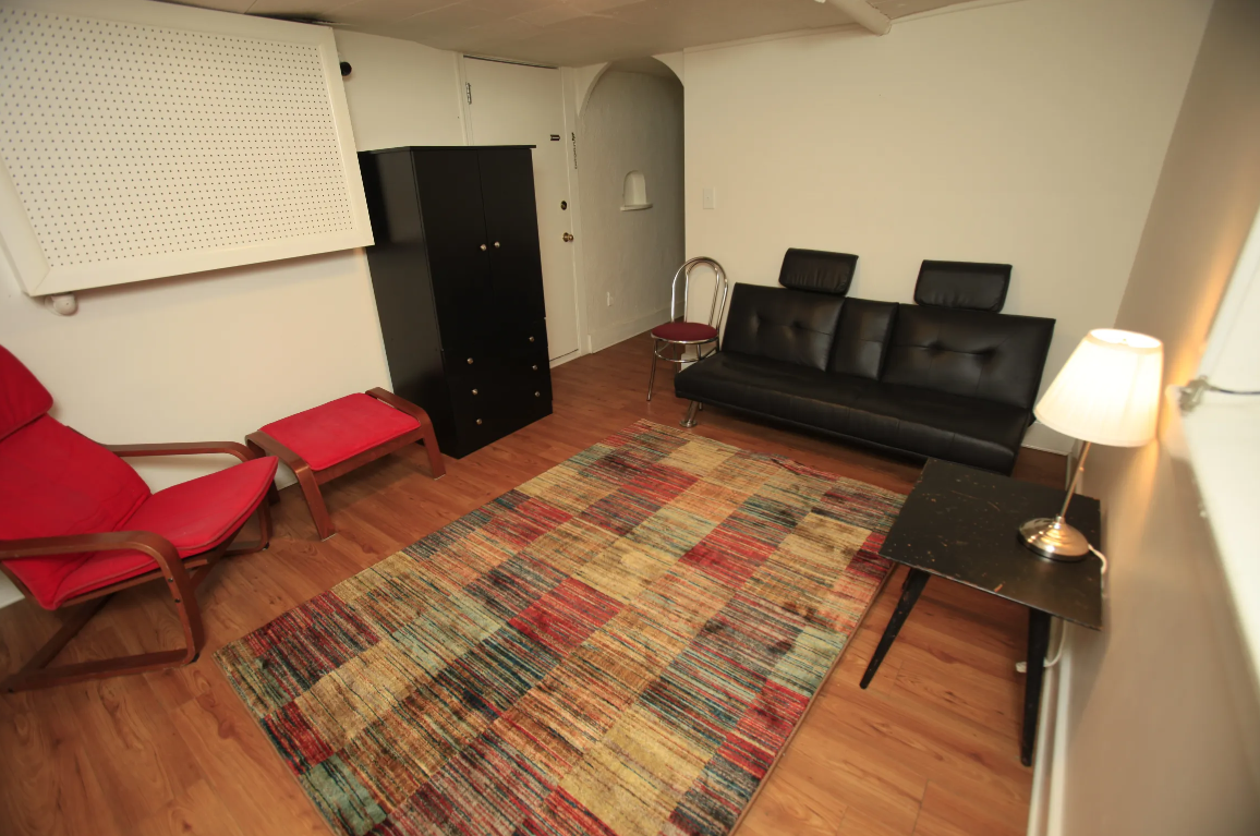 a living room with leather furniture and a rug
